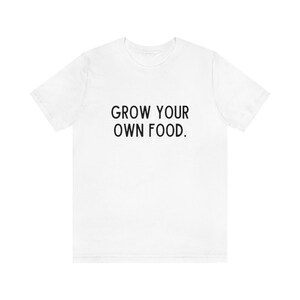 May include: White t-shirt with the text "GROW YOUR OWN FOOD." printed in black.