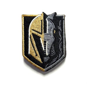 May include: Embroidered patch featuring the Vegas Golden Knights team logo. The patch is shield-shaped with a gold and black color scheme. The design includes a stylized knight's helmet and the letter "V".