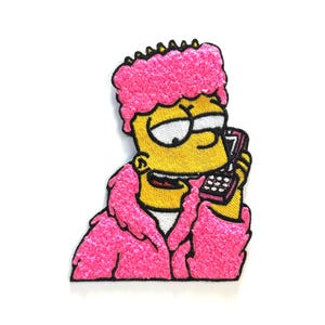 May include: Embroidered patch featuring Bart Simpson in a pink fluffy jacket and hair, holding a cell phone. The patch has a yellow face, white eyes, and a white shirt. The design is on a white background.