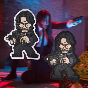 May include: Two cartoon-style patches featuring a man in a black suit holding a gun. The patches have a white border and are set against a blurred background of a man in a suit. The patches are in a cartoon style.