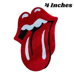 May include: Red, white, and black tongue and lips design rug. The rug is 24 inches in size.