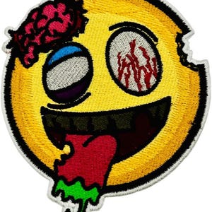 May include: Embroidered patch featuring a yellow zombie emoji with exposed brain, bloodshot eyes, and a dripping tongue. The patch has a black border and is designed with a stitched texture.