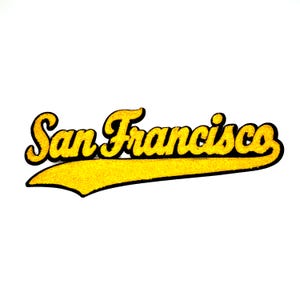 May include: A yellow and black San Francisco text graphic. The text is in a script font with a black outline and a yellow fill. The text is on a yellow banner with a black outline.