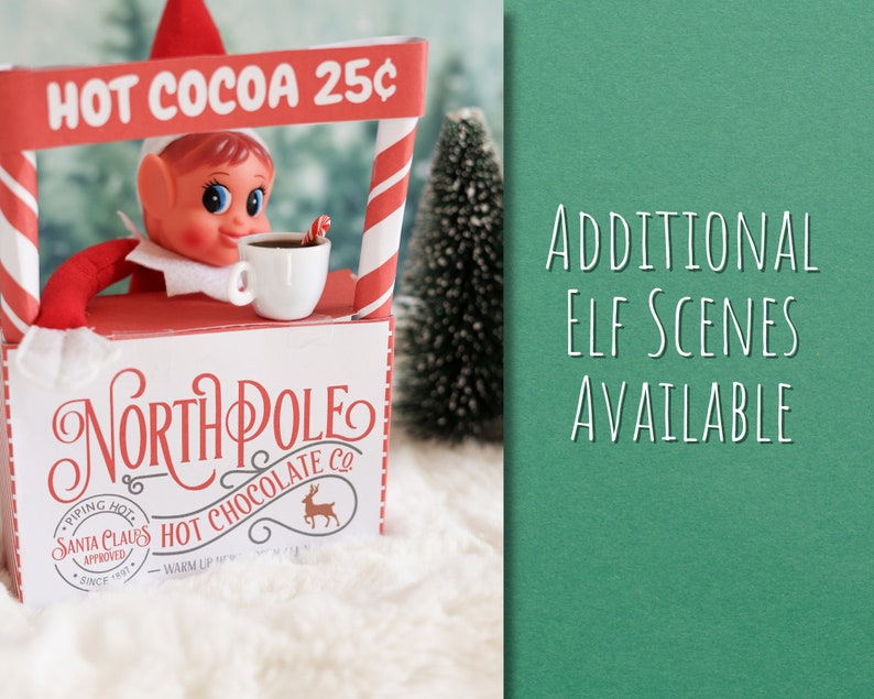 May include: A red and white elf-themed hot cocoa stand with a sign that reads "HOT COCOA 25&cent;". An elf is holding a cup of cocoa and a candy cane. The stand has a sign that says "NORTH POLE HOT CHOCOLATE CO."