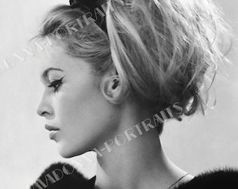 May include: Black and white portrait of a woman with a bouffant hairstyle and a black ribbon in her hair. She is wearing a fur collar.