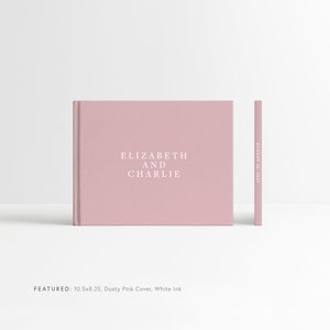 May include: Dusty pink wedding guest book with the text "ELIZABETH AND CHARLIE" and the date "AUGUST 26, 2023" printed in white ink. The book measures 10.5 inches by 8.25 inches.