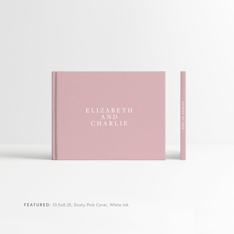 May include: Dusty pink wedding guest book with the text "ELIZABETH AND CHARLIE" and the date "AUGUST 26, 2023" printed in white ink. The book measures 10.5 inches by 8.25 inches.