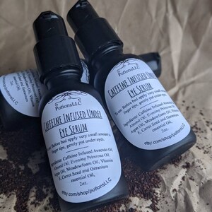 May include: Three 2 ounce bottles of caffeine infused under eye serum. The bottles are black with white labels and the text "Caffeine Infused Under Eye Serum" is printed on the label. The ingredients are listed on the label: Caffeine Infused Avocado Oil, Almond Oil, Evening Primrose Oil, Argan Oil, Meadowfoam Oil, Vitamin E, Carrot Seed and Geranium essential Oil.