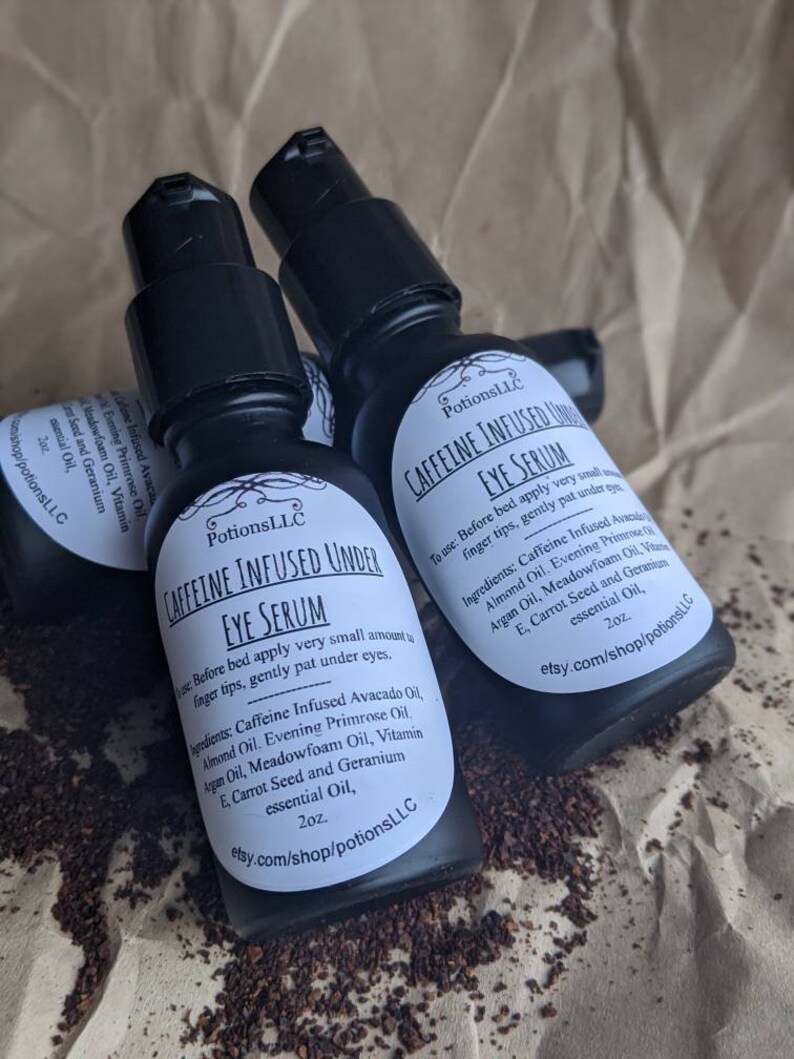 May include: Three 2 ounce bottles of caffeine infused under eye serum. The bottles are black with white labels and the text "Caffeine Infused Under Eye Serum" is printed on the label. The ingredients are listed on the label: Caffeine Infused Avocado Oil, Almond Oil, Evening Primrose Oil, Argan Oil, Meadowfoam Oil, Vitamin E, Carrot Seed and Geranium essential Oil.