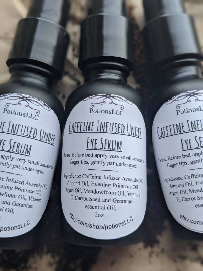 May include: Three black glass bottles with white labels containing caffeine infused under eye serum. The labels include the product name, ingredients, and instructions for use. The bottles are 2 ounces each and are available for purchase on Etsy.