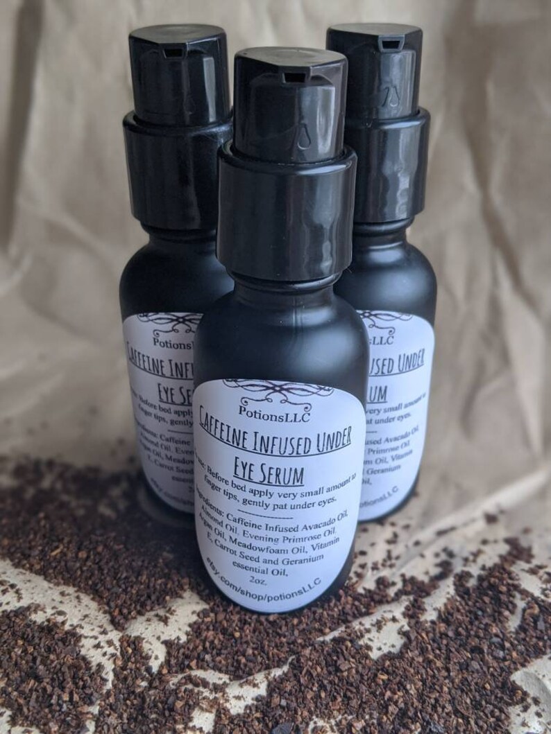 May include: Three black bottles of caffeine infused under eye serum with white labels. The label on the center bottle reads "Potions LLC Caffeine Infused Under Eye Serum 2 oz. Before bed apply very small amount to fingertips, gently pat under eyes. Ingredients: Caffeine Infused Avocado Oil, Almond Oil, Evening Primrose Oil, Meadowfoam Oil, Vitamin E Oil, Carrot Seed and Geranium essential Oil. etsy.com/shop/potionsLL.C"