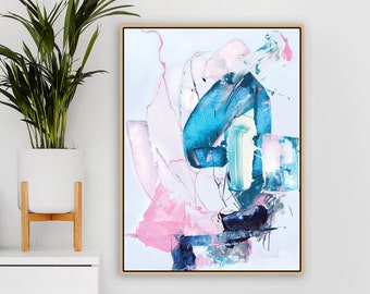 May include: Abstract painting with pink, blue, and white paint strokes. The painting is framed in a light wood frame and is hanging on a white wall.