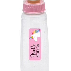 May include: A clear plastic baby bottle with a pink lid and a pink and white unicorn sticker with the name "Brielle Nicholson".