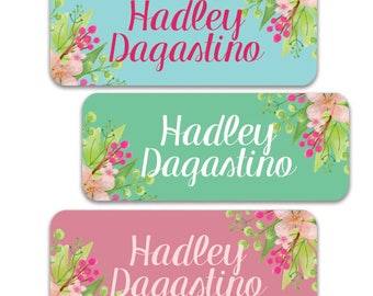May include: Three rectangular labels with a floral design and the name "Hadley Dagastino" written in a cursive font. The labels are in different colors: light blue, light green, and light pink.