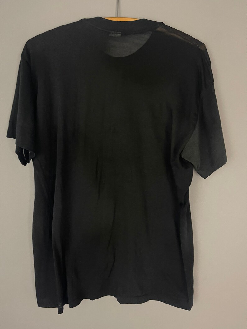 May include: A black short-sleeved t-shirt with a crew neck.