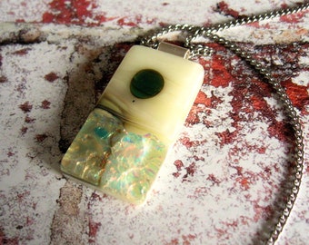 A cream fused glass pendant with dichroic glass sparkle, landscape design with a stainless steel chain. 30x18mm rectangular design. For her