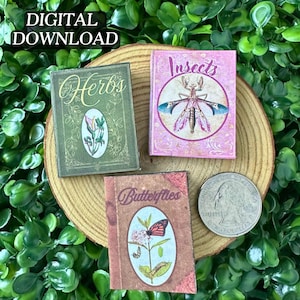 May include: Miniature books with botanical themes, including "Herbs," "Insects," and "Butterflies," are displayed on a wooden slice. The "Insects" book features a pink cover with a detailed insect illustration. The "Herbs" book has a green cover with floral art. A quarter is included for scale.