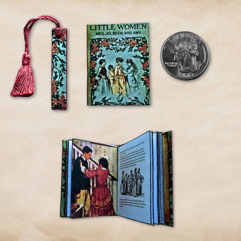 May include: Miniature open book and a tiny book titled "Little Women" with a floral design. A bookmark with a tassel and floral pattern is also present. A U.S. quarter coin is next to the book for size comparison.