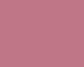 May include: A solid, plain, dusty rose colored background.