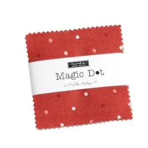 May include: A red fabric square with white polka dots. The fabric is labeled "Magic Dot" by "22" Little Boutique."