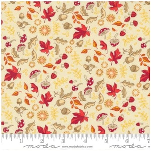 May include: A cream-colored fabric with a repeating pattern of red leaves, mushrooms, acorns, and small yellow flowers. The fabric is marked with a ruler in inches.