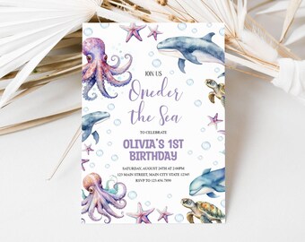 May include: A purple and white invitation card with an under the sea theme. The card features an octopus, a dolphin, a turtle, and starfish. The text on the card reads "Join us Oneder the Sea to celebrate Olivia's 1st Birthday".