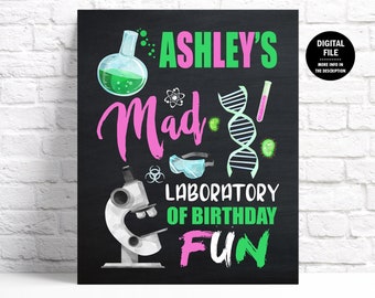 May include: A black chalkboard sign with the text "Ashley's Mad Lab! Laboratory of Birthday Fun" in pink and green. The sign features a beaker, a microscope, safety goggles, a DNA strand, and other science-themed illustrations.