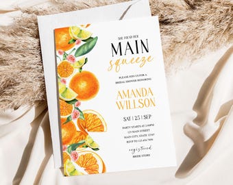 May include: Orange citrus fruit bridal shower invitation with the text "She found her Main Squeeze" and the bride's name "Amanda Willson". The invitation includes the date, time, and location of the shower, as well as the RSVP information.