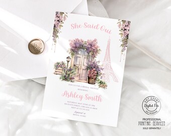 May include: A pink and white bridal shower invitation with a watercolor illustration of a Parisian door with flowers and the Eiffel Tower. The text reads "She Said Oui" and "Ashley Smith".