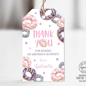 May include: A white thank you tag with pink and purple donuts, pink polka dots, and the text "THANK YOU. FOR MAKING MY BIRTHDAY SO SWEET! Love, Gabriella".