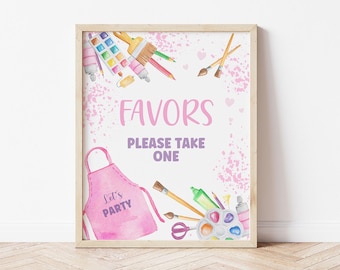 Puede incluir: Un cartel rosa y blanco con las palabras "Favors Please Take One" y un delantal rosa con las palabras "Let's Party". El cartel está decorado con pinceles de acuarela, pintura y otros materiales de arte.