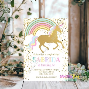 May include: A white invitation card with a gold glitter background and a rainbow unicorn illustration. The text on the card reads "Join us for a magical day! Sabrina is turning 5! Saturday, April 5th at 1:30 pm 1234 Your Address City, State 12345 RSVP to Isabelle at 123.4567 Dancing Frog Invitations".