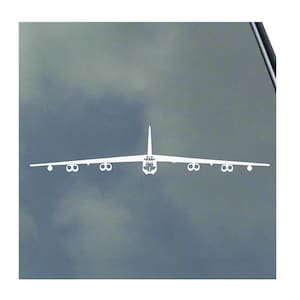 May include: A white silhouette of a B-52 bomber airplane against a gray background.