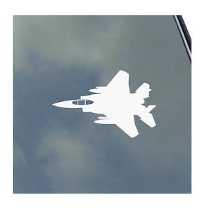 May include: White silhouette of a fighter jet on a gray background.