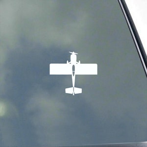 May include: White silhouette of a small airplane with wings spread out, viewed from above. The airplane is on a gray background.