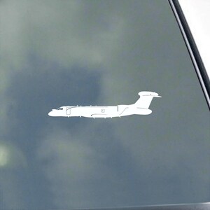 May include: A white decal of a passenger airplane, featuring a long fuselage, a tail fin, and wings. The aircraft is depicted in a side profile, with detailed windows and doors. The decal is designed to be applied to a car window or similar surface.