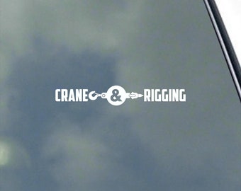 May include: White vinyl decal with the text "CRANE & RIGGING" and a graphic of a hook and chain.