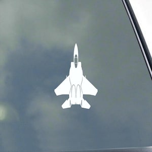 May include: White silhouette of a fighter jet on a gray background.