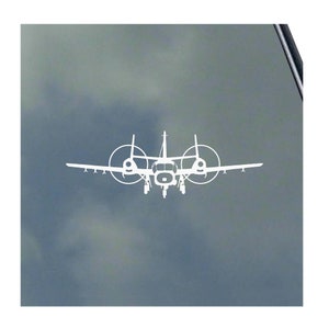 May include: A white silhouette of a twin-engine turboprop aircraft with propellers on the wings. The aircraft is flying in a cloudy sky.
