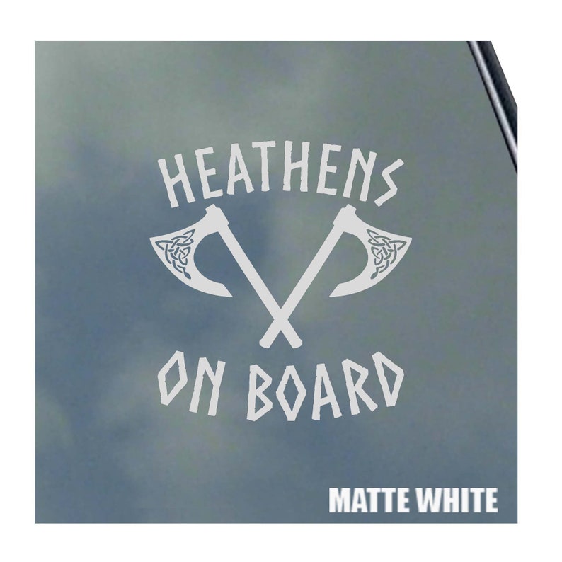 May include: White vinyl decal with the text "HEATHENS ON BOARD" and two crossed axes with Celtic knot designs. The decal is on a matte white background.
