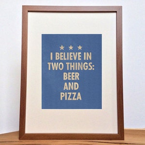 May include: A framed print with a blue background and white text that reads "I believe in two things: beer and pizza".