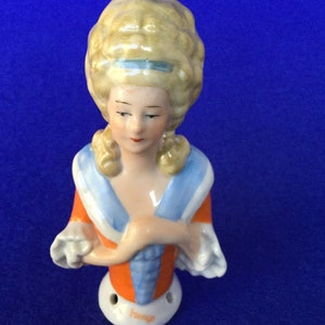 1920s Regency Lady Half Doll  - Foreign Glazed Bisque Half Doll with an Orange & Blue Blouse and Pompadour Hairstyle
