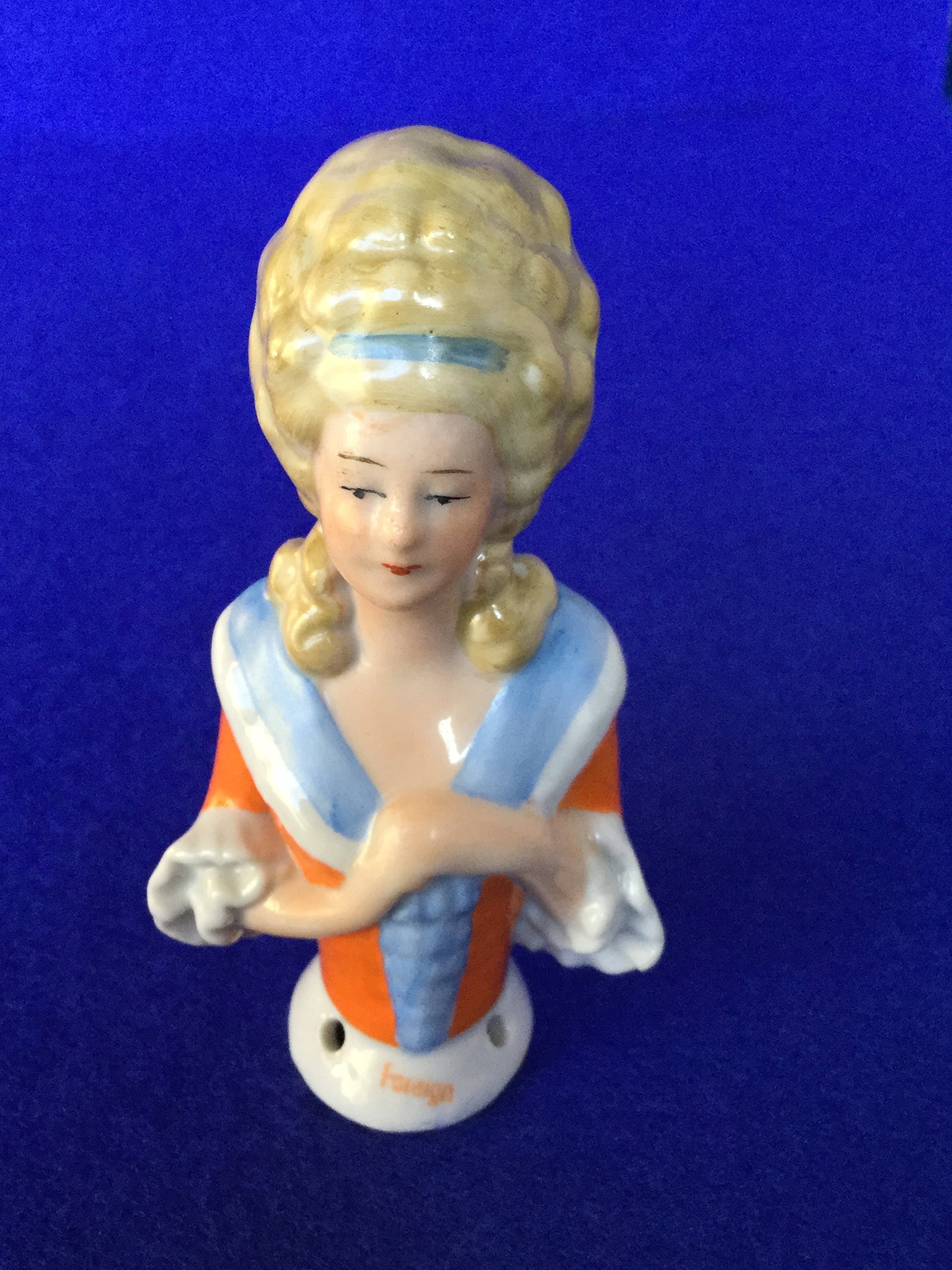 1920s Regency Lady Half Doll - Foreign Glazed Bisque Half Doll with an Orange & Blue Blouse and Pompadour Hairstyle .br 1920s Regency Lady Half Doll - Foreign Glazed Bisque Half Doll with an Orange & Blue Blouse and Pompadour Hairstyle .br