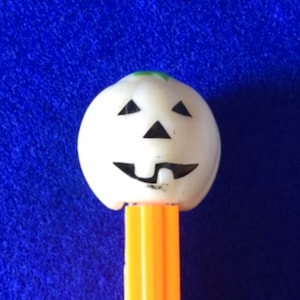 Rare Vintage 1980 Pez Dispenser Glow In The Dark White Face Pumpkin Head No. 1 with Green Hair