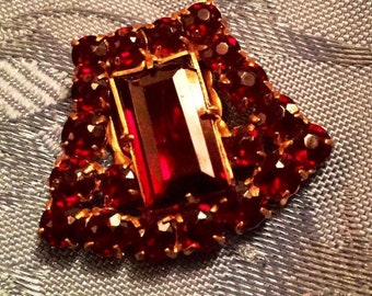 1930s Art Deco Dress Clip with a Rectangular Claw Set Glass Garnet Cabochon with a 20 Small Glass Garnet Surround on Gold Tone
