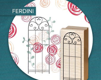May include: A wooden stamp with a black trellis design, featuring a decorative arched top with heart-shaped details. The stamp is set against a white background with rose patterns and the text "FERDINI".