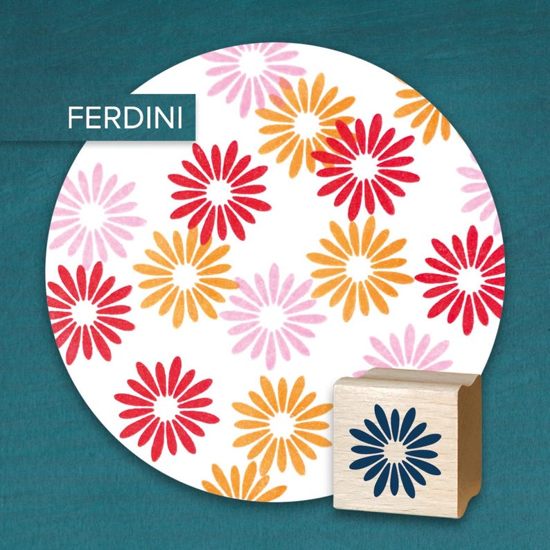 May include: A wooden stamp with a blue flower design next to a white circle with a repeating pattern of red, orange, and pink flowers. The word "FERDINI" is in a white box in the upper left corner.