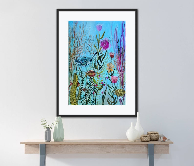 May include: A watercolor painting of a colorful underwater scene with fish, flowers, and plants. The background is a light blue color, and the painting is framed in black.