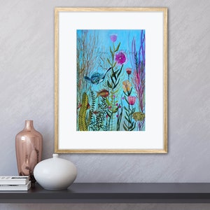 May include: A framed watercolor painting of a blue bird flying over a field of colorful flowers and green plants on a light blue background.