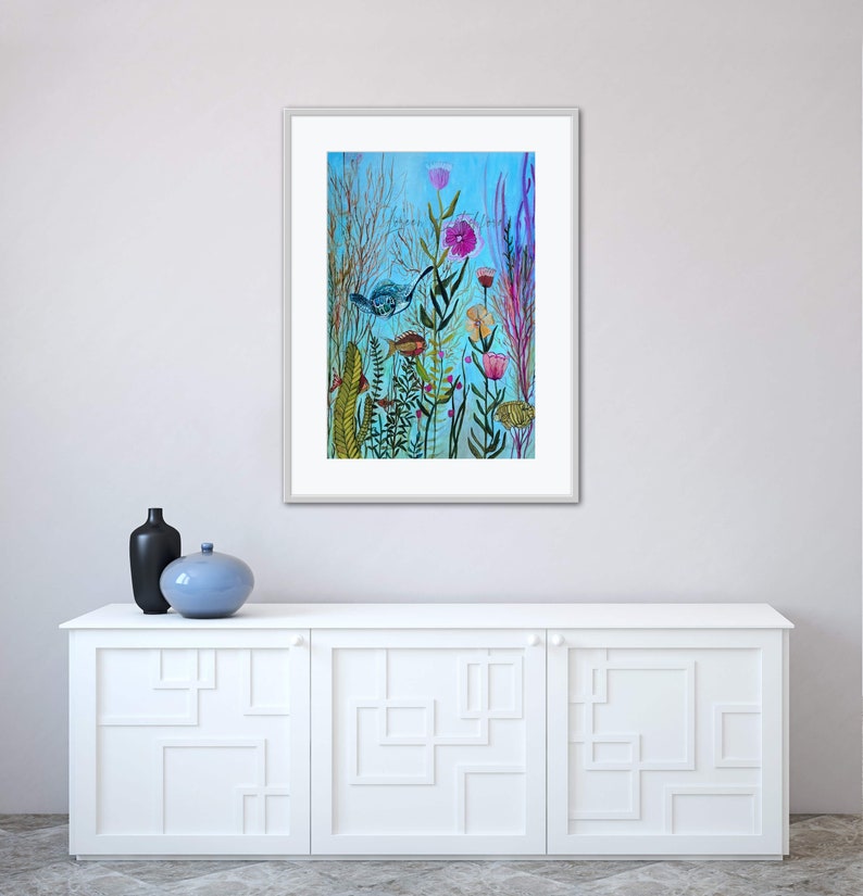 May include: A framed watercolor painting of a whimsical underwater scene with colorful fish, flowers, and plants on a blue background.